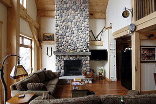 black suede 2-seat sofa beside brown concrete fireplace